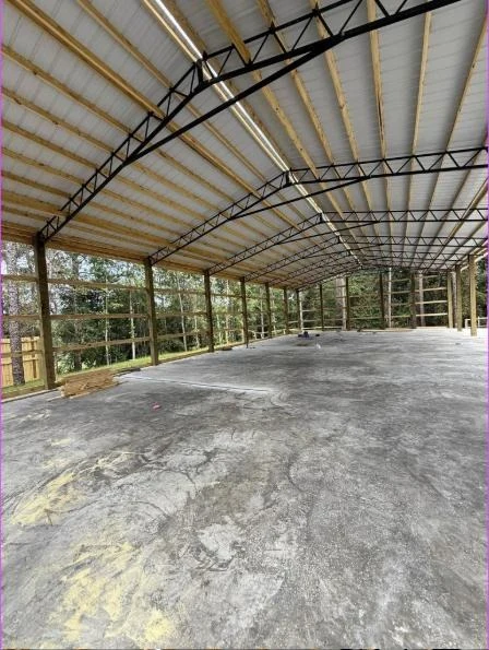 Interior of an open span steel frame workshop with a poured concrete slab
